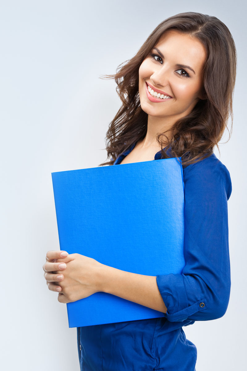 Portrait of young happy smiling businesswoman with blue folder, with blank copyspace area for slogan or text, posing at studio